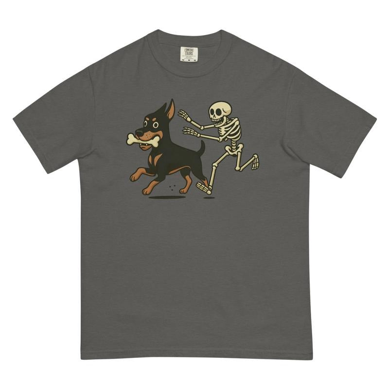 Funny Skeleton Chasing Doberman Dog Halloween T-Shirt Spooky Graphic Tee Comfort Colors Style Unisex Relaxed Fit 100% Ring-Spun Cotton Honduras Made Casual Cartoon Short Sleeve Crew Neck Summer