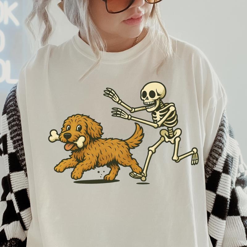 Funny Skeleton Chasing Golden Doodle Dog Halloween T-Shirt | Spooky Graphic Tee Comfort Colors Style