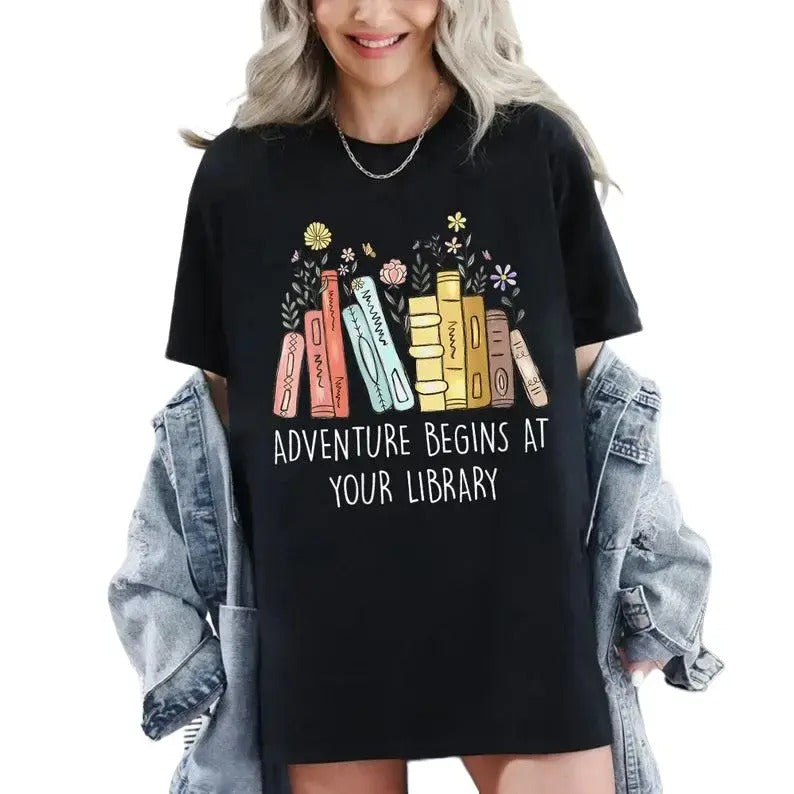 Adventure Begins At Your Library Shirt, Bookish T-Shirt, 2024 Summer Reading Shirt, Literature Shirt, Librarian Shirt, Gift for Her Comfort Cotton Collar Fabric Seamless Top Womenswear Garment