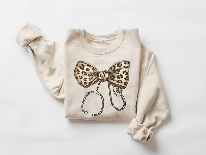 Coquette Nurse Stethoscope Bow Sweatshirt, Leopard Bow Nurse Sweatshirt, Nurse Shirt, Gift for Nurse, ER RN Nurse Appreciation Shirt, Nurse Bow Shirt, Coquette Nurse Shirt, Nurse Ribbon Shirt