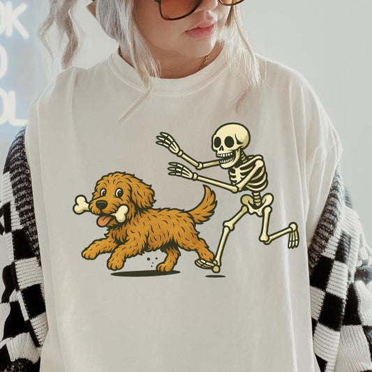 Funny Skeleton Chasing Golden Doodle Dog Halloween T-Shirt | Spooky Graphic Tee Comfort Colors Style