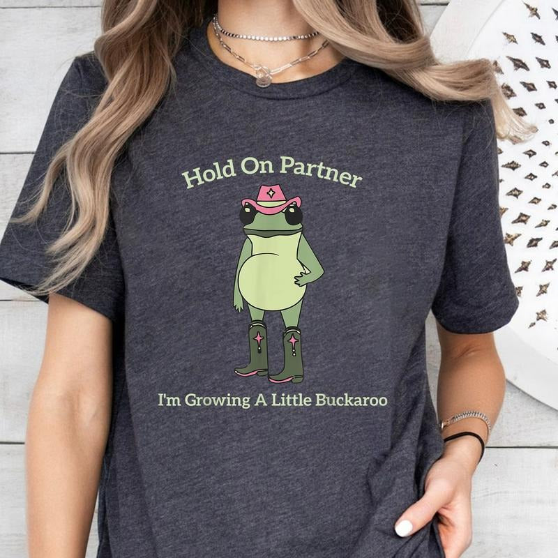 Hold On Partner I'm Growing A Little Buckaroo T-Shirt Sweatshirt Hoodie, Cute Animal T-Shirt, Funny Frog T-Shirt, Unhinged T-Shirt, Pregnancy Reveal T-Shirt, First Time Mom Gift