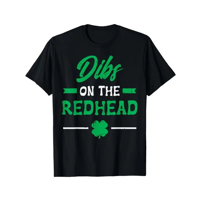 Playful | St. Patrick's Day "Dibs on the Redhead" Men's & Women's T-Shirt - Black Cotton Tee with Clover Design, Short Sleeves, Round Neck, Festive Event Apparel | Shamrock Motif Clothing | Comfortable made in usa