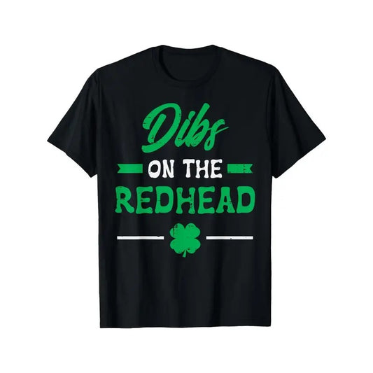 Playful | St. Patrick's Day "Dibs on the Redhead" Men's & Women's T-Shirt - Black Cotton Tee with Clover Design, Short Sleeves, Round Neck, Festive Event Apparel | Shamrock Motif Clothing | Comfortable made in usa