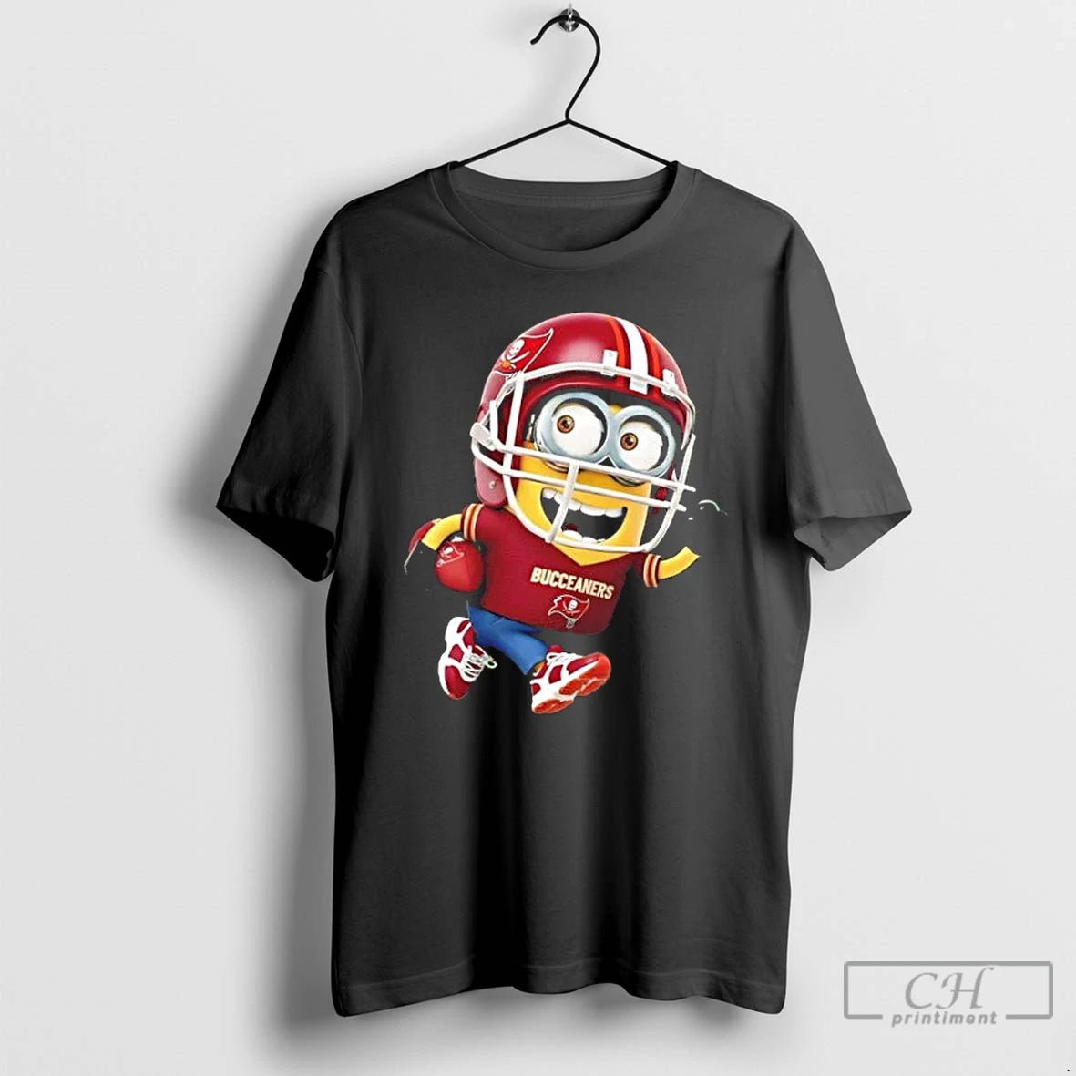 Premium Minions Is Holding A Ball And Smiling At Tampa Bay Buccaneers Fans T Shirts