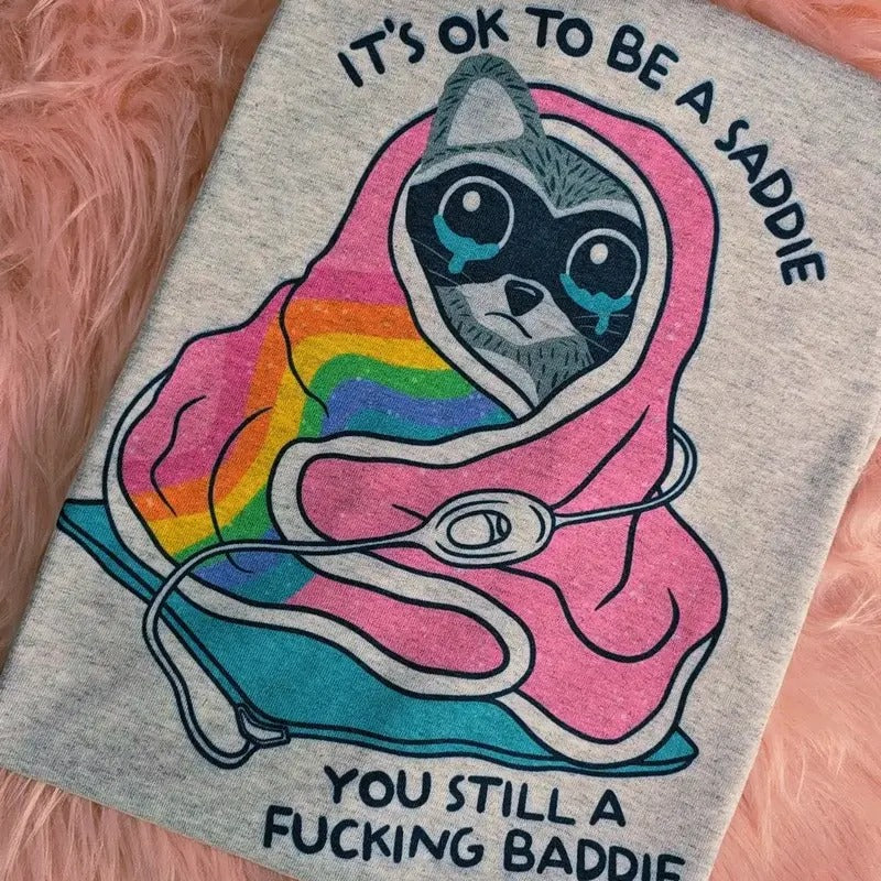 Raccoon it's ok to be a saddie you still a baddie Graphic Tee Hoodie, Sweatshirt | DripVista.com