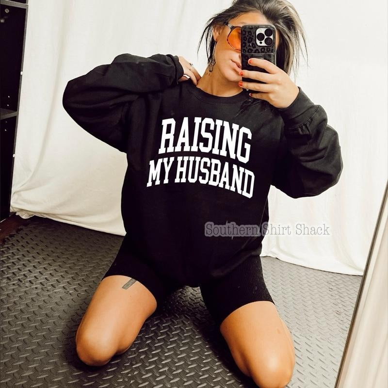 Raising my Husband Sweatshirt | Black Sweatshirt graphic shirt unisex style Hoodie | DripVista.com