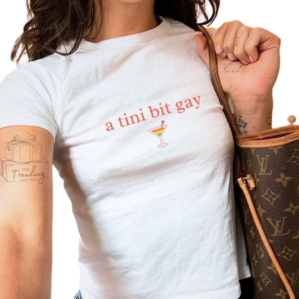 Subtle Lesbian Baby Tee, WB shield Tini Bit Gay Sapphic Shirt, WLW Gift Ideas, Femme Pride Month Girlfriend Tee Hoodie,...