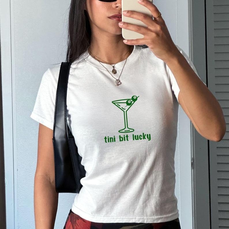 tini bit lucky baby tee, martini tshirt, WB shield Spiky hair fighters tee, cocktail shirt Hoodie, Sweatshirt | DripVista.com